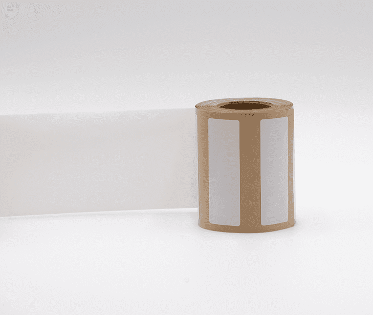 CSI-360-Labels-Rollpng - Unified Information Devices Brown label roll standing upright with two white label panels on a white background.