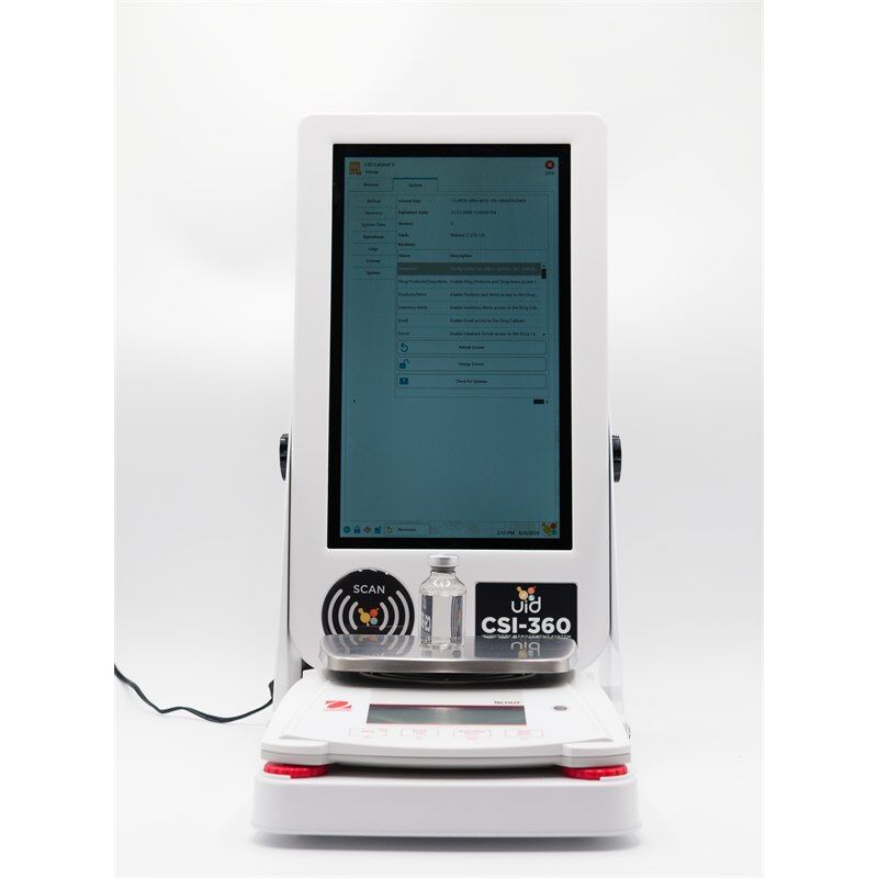 CSI-desk-full-with-scale--bottle-1-800x800 - Unified Information Devices Tall medical diagnostic kiosk with a large touchscreen display, labeled CSI-360, on a white stand with a tray holding a small bottle.